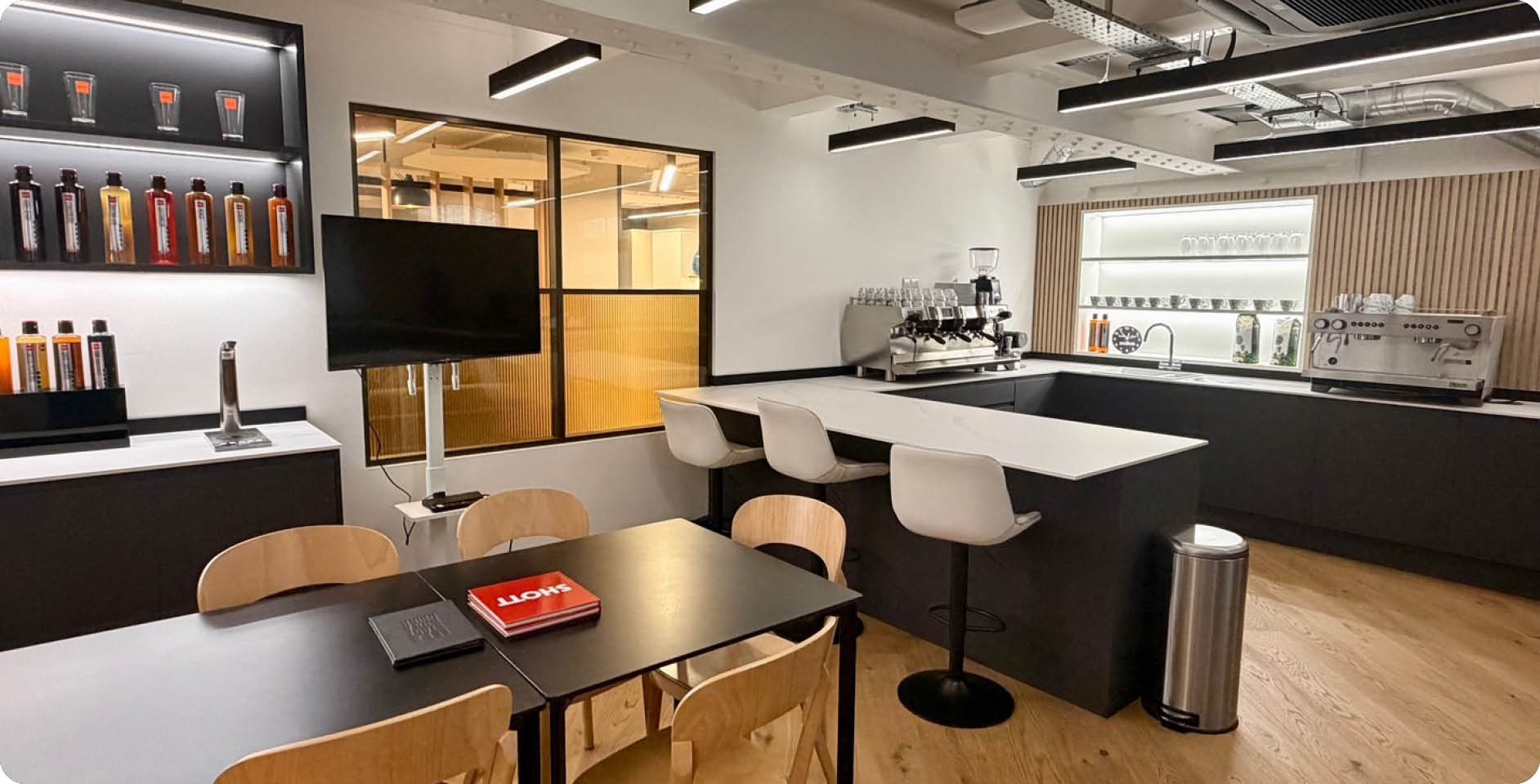 A large kitchen with a counter full of coffee makers and cups. AI generated content